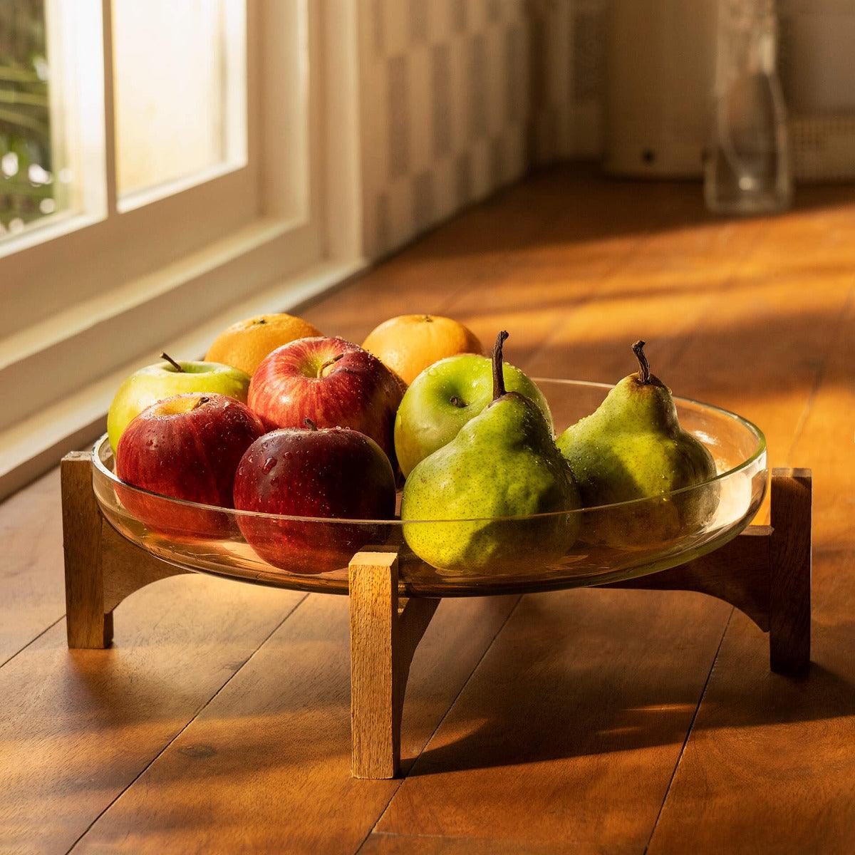 clear glass bowl with wooden stand