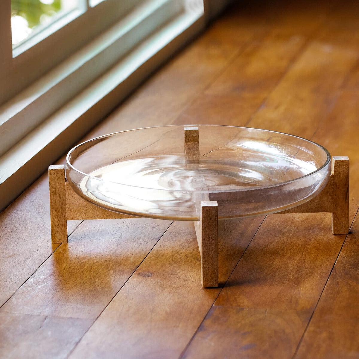 clear glass bowl with wooden stand