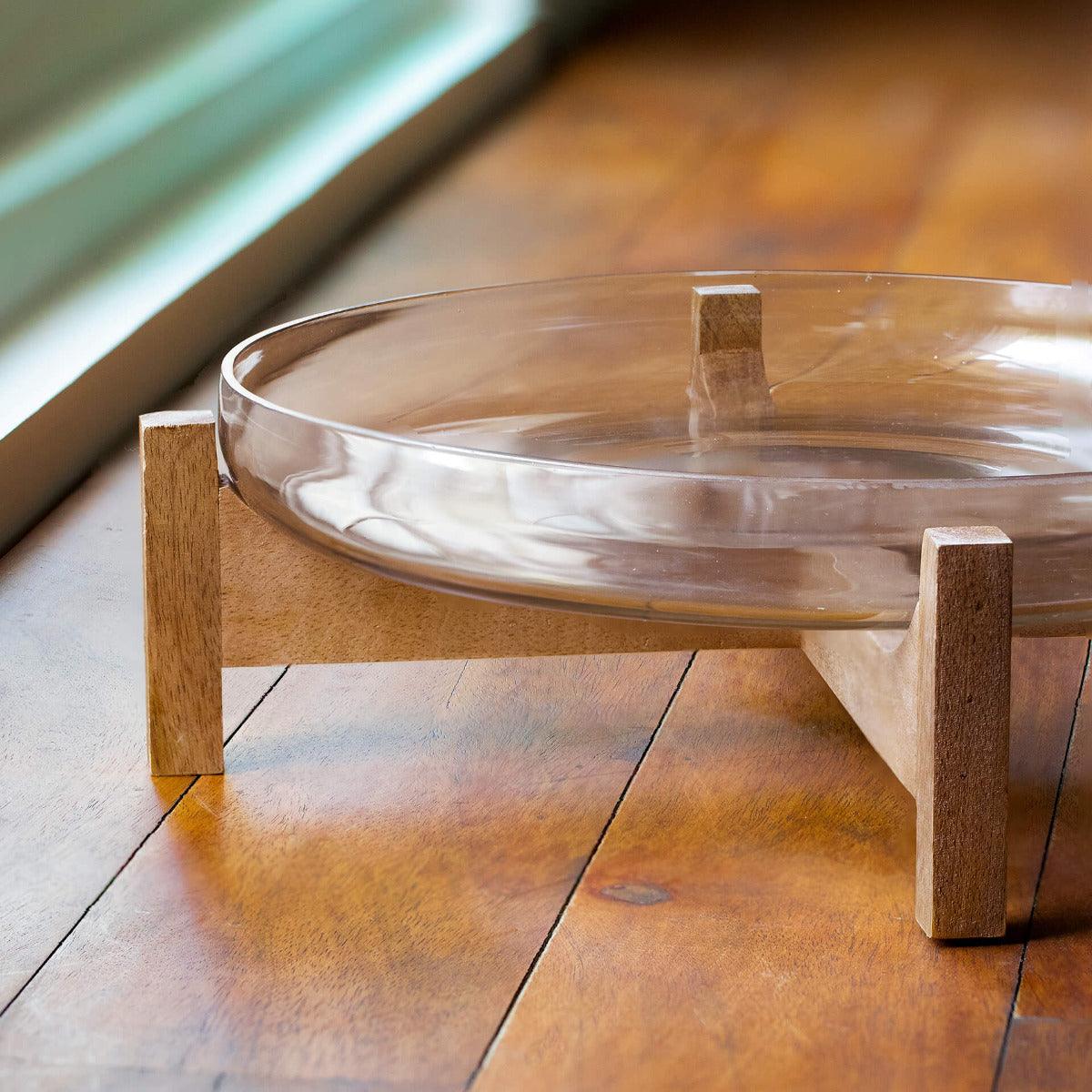 clear glass bowl with wooden stand