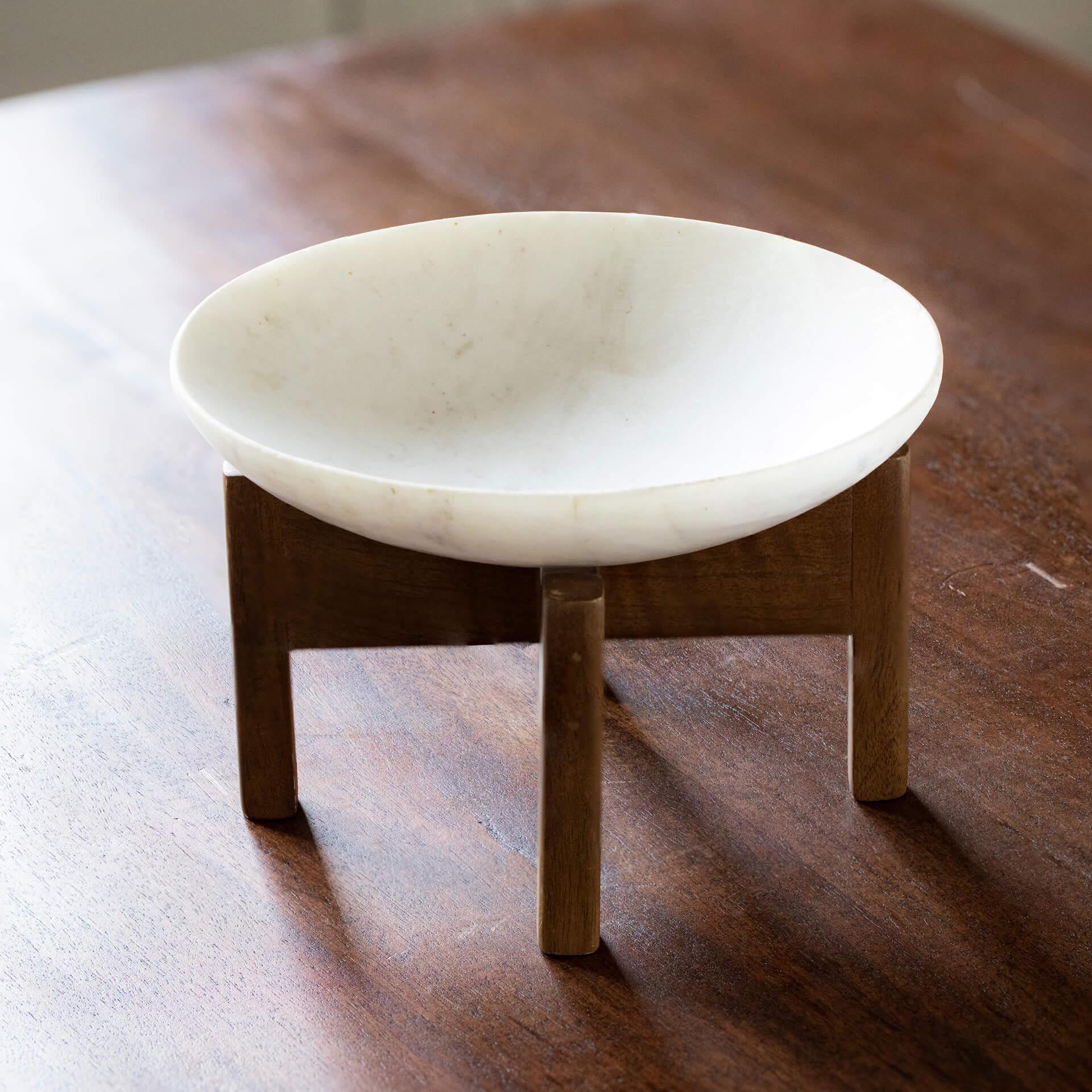 white marble bowl with wooden stand