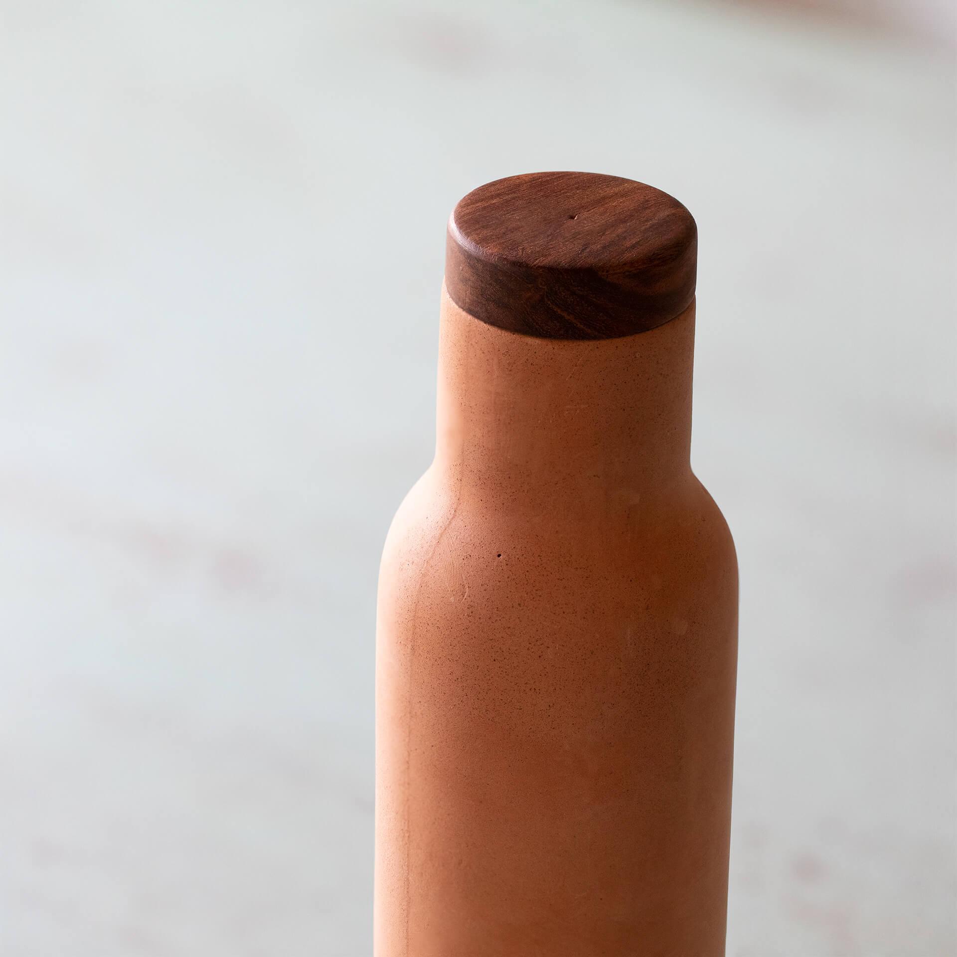 terracotta bottle with wooden lid